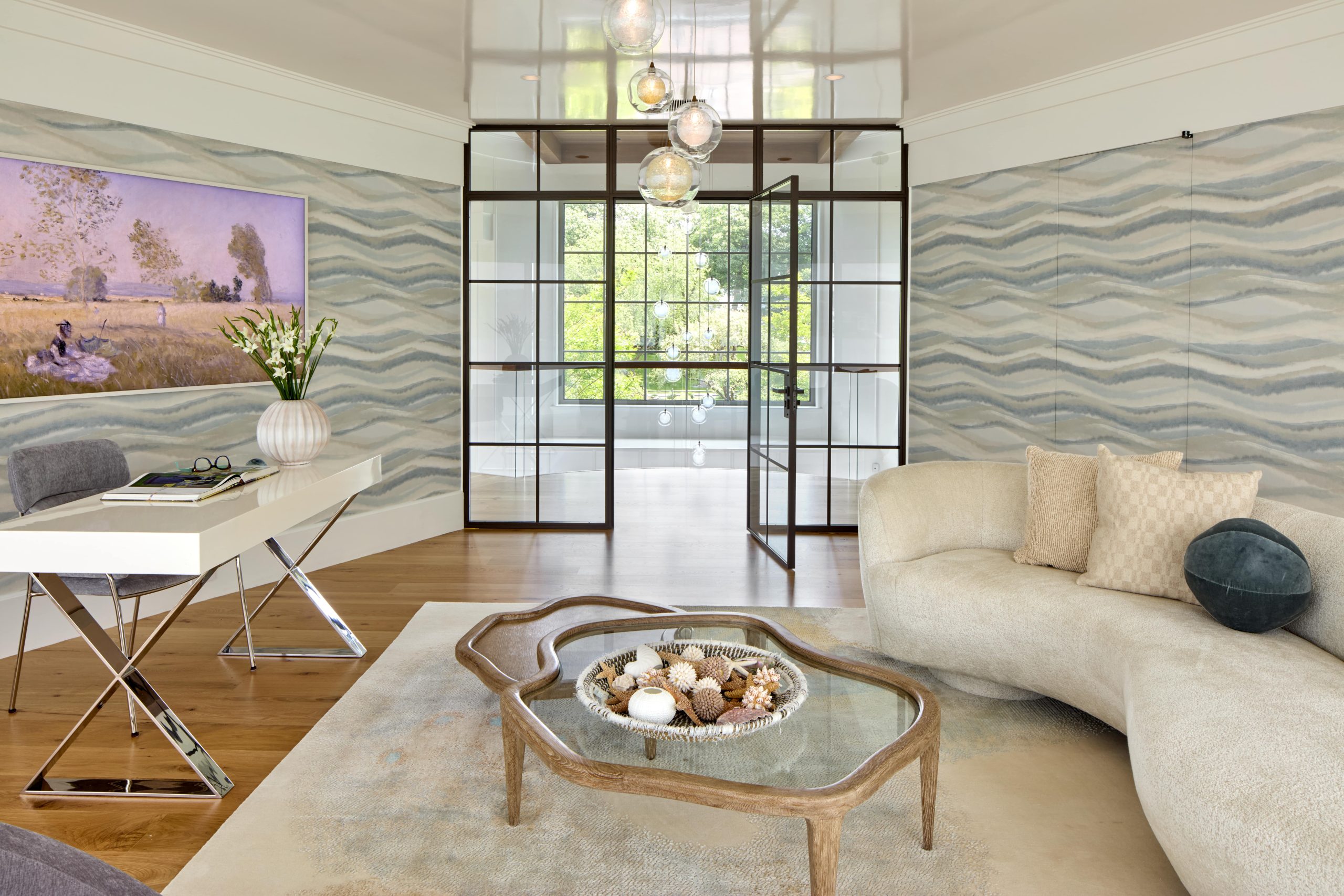 Coveledge office with a desk, chair, coffee table in the center of the room, and a couch with the glass door open leading to the open hallway